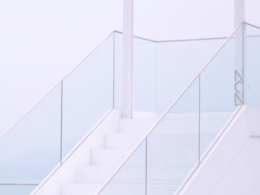 Glass handrails on modern white staircase